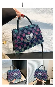 Detail of tweed crossbody bag with color plaid pattern, bow accent and frayed edges