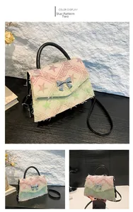 Detail of colorful denim plaid bag with star pattern, fringe edges and bow lock