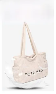 Détail du sac cabas en velours côtelé beige montrant la texture et la broderie noire