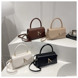 Macro view of four elegant crossbody bags with gold A-shaped buckles on a display stand