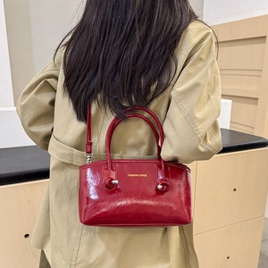 Fashionable red leather tote bag with FASHION & BAGS print and adjustable shoulder strap