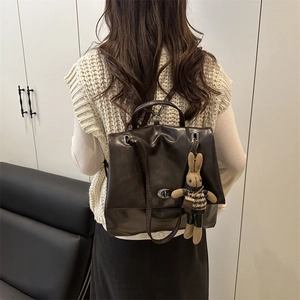 Vintage brown oil wax leather backpack with a cute bunny charm on back of a model