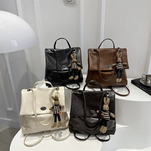 Minimalist soft leather vintage backpack in black, brown and beige colors with rabbit charms