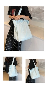 Detailed close-up of light mint nylon drawstring tote bag with adjustable black cord lock