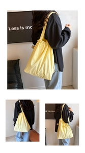 Close-up of lightweight yellow nylon tote bag with drawstring closure and large capacity
