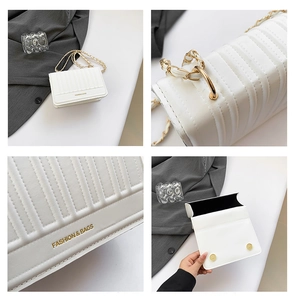 Detail view of white chain bag featuring vertical embossing and gold metal strap