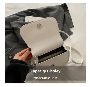 Detail view of the white saddle bag interior showing storage capacity for a smartphone