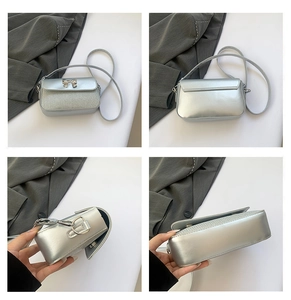 Details einer silbernen Umhängetasche mit Metallschleife und glitzernder Textur