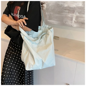 Detail view of the drawstring pleated texture on light blue large capacity tote bag