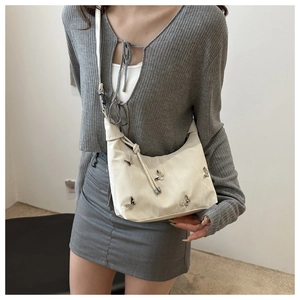Chic off-white rivet butterfly crossbody bag with silver accents for women