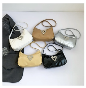Detailed arrangement of crescent shoulder bags with sparkling heart rhinestone accents