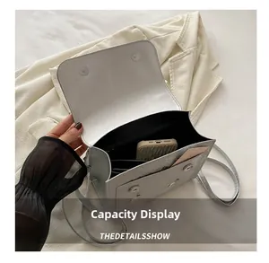 Silver metallic shoulder bag with multi-layer accordion compartments for phone and cards
