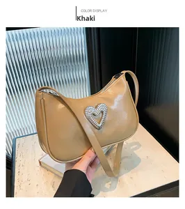Close-up of khaki PU leather underarm bag featuring a silver sparkling heart decoration