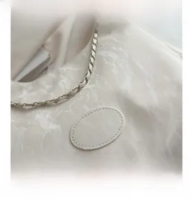 Detail of marble texture PU leather shoulder bag with gold metal chain strap