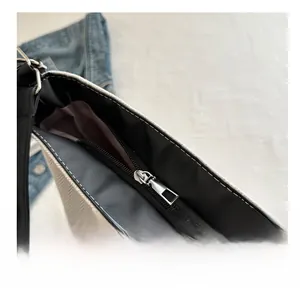 Close-up of smooth metal zipper and premium leather trim on canvas tote bag