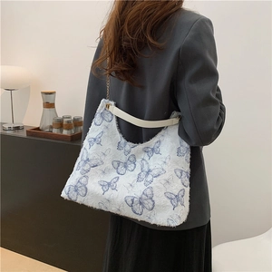 White faux fur tote bag with blue butterfly pattern and golden chain shoulder strap