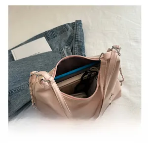 Top view of a pink leather tote bag showing large capacity with laptop and wallet