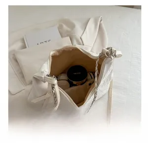 Interior view showing the large capacity of a cream white quilted chain tote bag