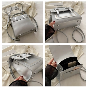 Detail view of silver metallic backpack with rivets, inner compartments, and base studs
