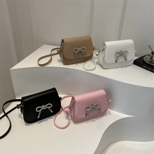 Mini saddle crossbody bags in brown, white, black and pink with rhinestone bow buckle