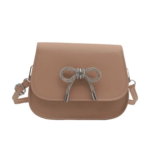 Pink minimalist saddle crossbody bag with sparkling rhinestone bow detail and shoulder strap