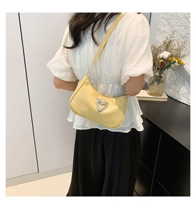 Detailed back view of a bright yellow baguette shoulder bag with a rhinestone heart