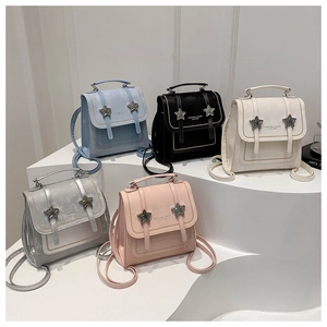 Close-up of mini leather backpacks in five colors with star buckles and yellow stitching