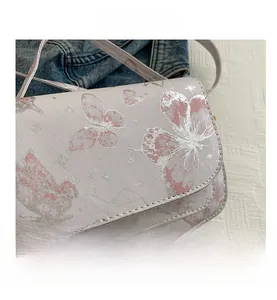 Close-up of pink butterfly prints and fine star details on luxury small square bag