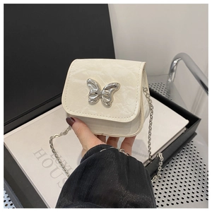 Detailed close-up of marble pattern crossbody bag with silver butterfly buckle