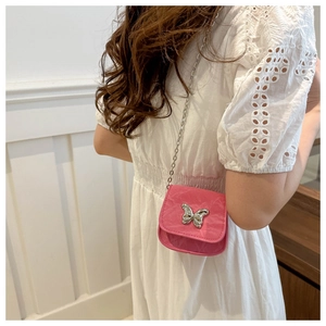 Detail of pink crossbody bag with silver butterfly clasp and metal chain strap