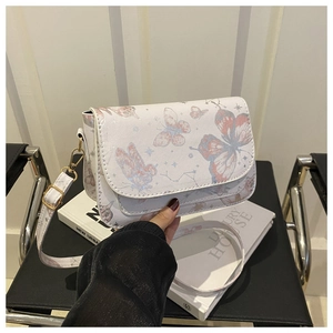 Close-up of white leather crossbody bag featuring elegant pink and blue butterfly prints