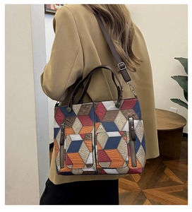 Detail of colorful 3D geometric patchwork tote bag with dual front zipper pockets