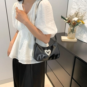 Chic black patent leather shoulder bag with sparkling silver rhinestone heart ornament