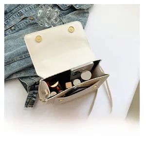 Top view of cream woven crossbody bag interior showing spacious storage for essentials