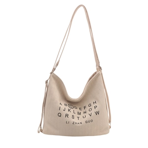 Minimalist cream canvas tote bag with black letter print and adjustable shoulder straps