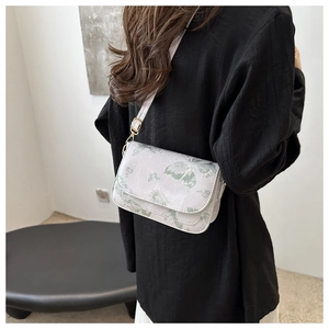 White butterfly print shoulder bag with adjustable strap and golden metal buckle details
