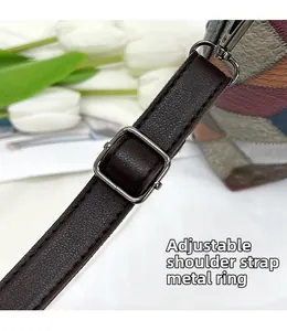 Detail of adjustable dark brown litchi leather strap with gunmetal buckles and floral decor