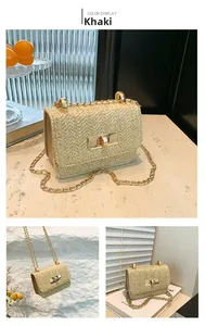 Detail view of khaki straw crossbody bag featuring herringbone weave and gold chain strap