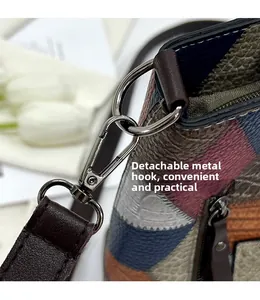 Close-up of metal hook and detachable strap on a multi-color textured leather tote