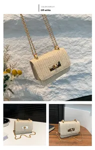 Detail of cream woven straw mini crossbody bag with golden metal twist lock and chain