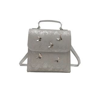Silver metallic butterfly backpack with handle and five metal butterfly decorations