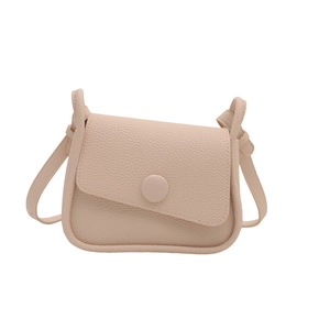 Minimalist lychee pattern beige saddle crossbody bag with a round buckle and flap cover