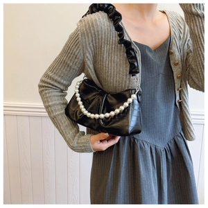 Glossy black patent leather underarm bag with pearl chain and ruffled shoulder strap