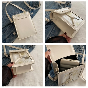 Detailed interior of a cream printed crossbody phone bag showing smartphone storage capacity
