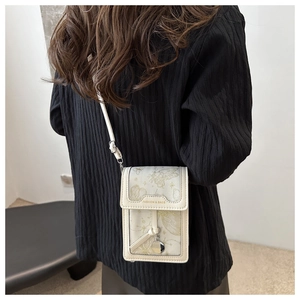 Detail of floral butterfly print on white PU leather crossbody small phone bag