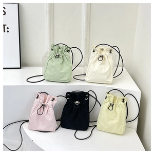 Collection of five colorful drawstring canvas bucket bags shown in various pastel shades