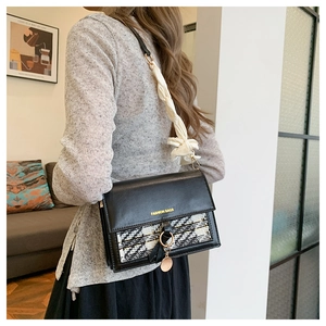 Detail of tweed flap bag featuring fashion text and silk scarf wrapped shoulder strap