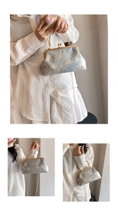 Detail of vintage blue jacquard handbag with gold leaf embroidery and metal clasp