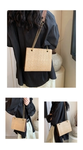 Detail of woven straw tote bag featuring golden chain straps and textured weave finish