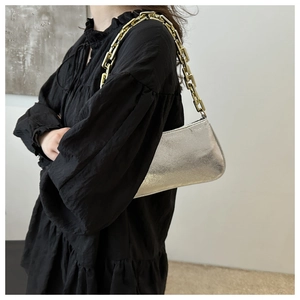 Metallic chain shoulder bag in silver mirror finish with chunky gold-tone handle strap